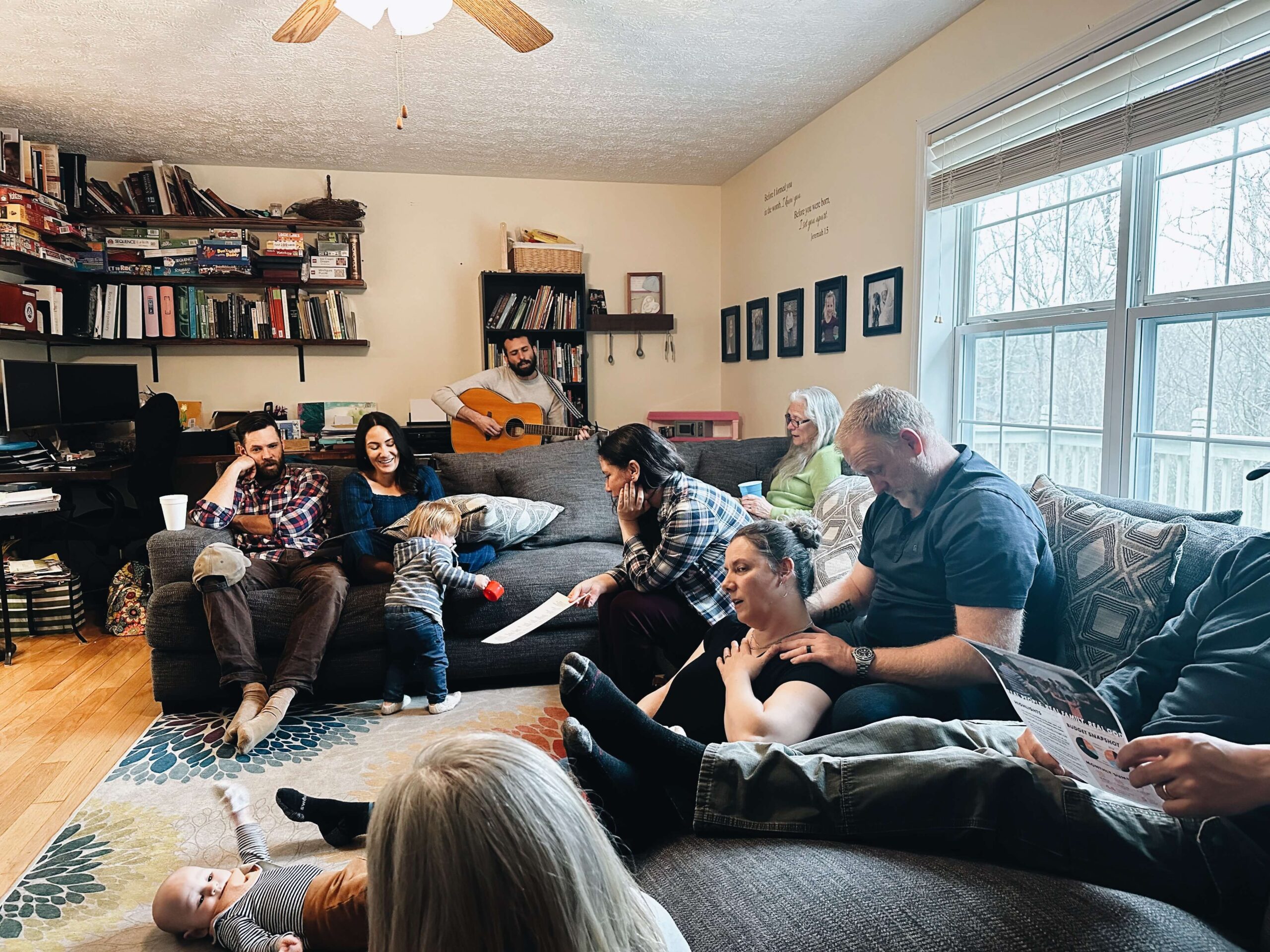 Adults and children gathered together in a home with music